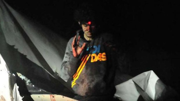 "This guy is evil": Dzhokhar Tsarnaev emerges with a red dot on his forehead from a police rifle.