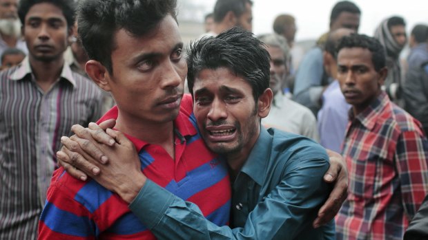 Bangladeshi people cry as rescuers search the River Padma after the ferry accident.