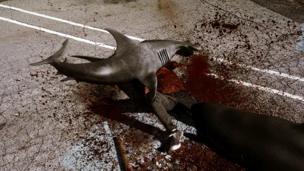 In this image released by Syfy, sharks attack a man in a scene from the Syfy original film <i>Sharknado</i>.