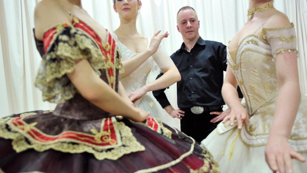 Adrian Clarke admires his work as three ballerinas are fitted in different styles.