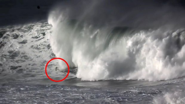 Garrett McNamara is swallowed by the wave's massive lip.