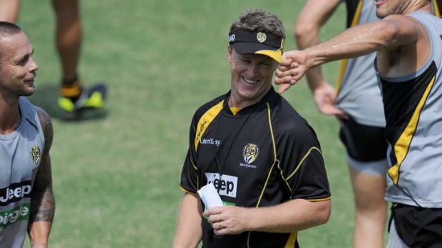 Damien Hardwick shares a joke with his players at training.