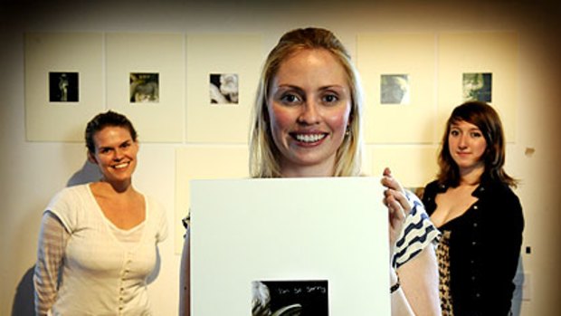 Fallen Angel: Alexandra Gee holds up a piece of art dedicated to her sister Nellie, made with the help of Birra-li Ward (left) and Greta Mcmahon (right).