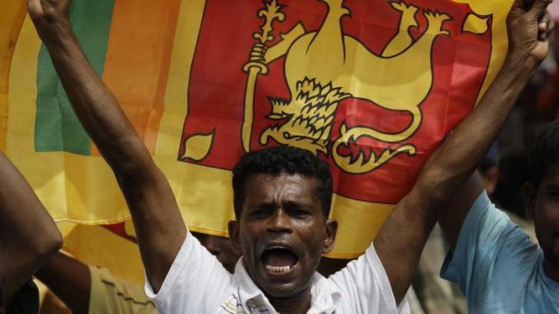 A Sri Lankan man waves his national flag in central Colombo.