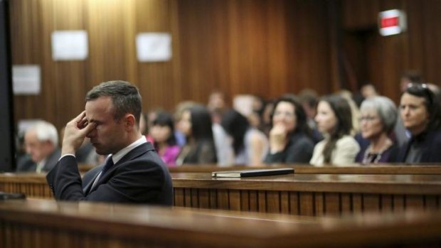 Grilling over ... Oscar Pistorius rubs his eye in court in Pretoria after earlier questioning by state prosecutor Gerrie Nel.