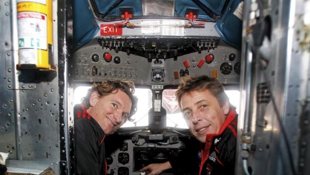 Bombers coach James Hird and assistant coach Mark Thompson in the cockpit of a DC-3.
