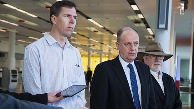 "It's quite possible there'll be no quick response to this": Australian Transport Safety Bureau Chief Commissioner Martin Dolan flanked by senior transport investigators Paul Ballard and John Robins as they prepare to depart for Kiev.