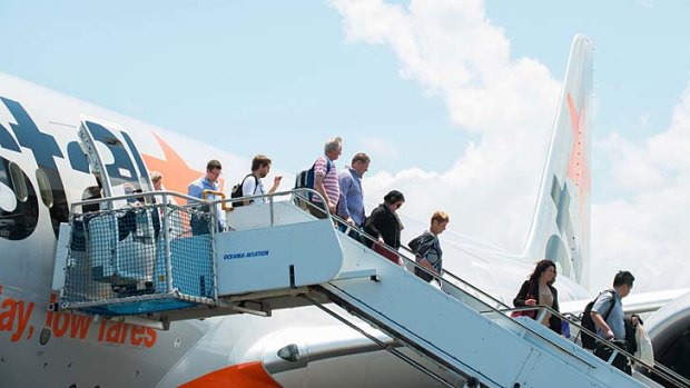 Passengers disembark Jetstar's first commercial Dreamliner flight after landing on the Gold Coast.