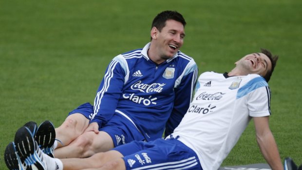 A Belgian walks into a bar ...  Lionel Messi shares a joke with teammate Fernando Gago during a training session in Vespasiano.