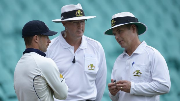 Troubled match: Matthew Wade speaks with the umpires at the SCG on Saturday.