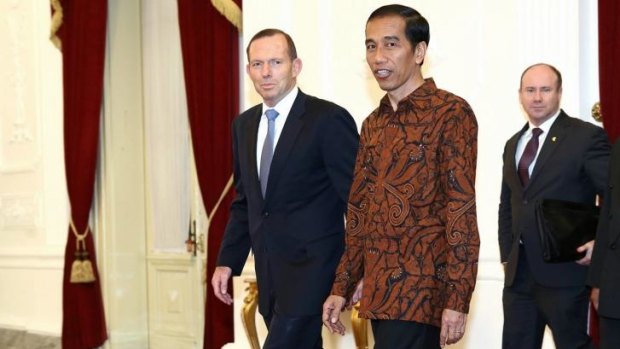 Indonesian President Joko Widodo (right) meets Australian Prime Minister Tony Abbott prior to a meeting at the Presidential Palace in Jakarta.
