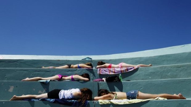 Girls sunbathing at Newcastle Ocean Baths.