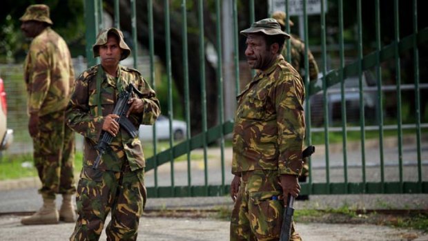 Calm prevails as soldiers patrol in Port Moresby after the failed coup attempt led by retired colonel Yaura Sasa.
