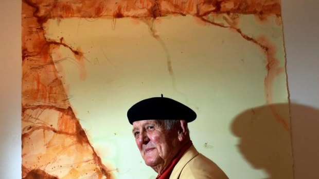 John Olsen with one of his paintings of Lake Eyre.