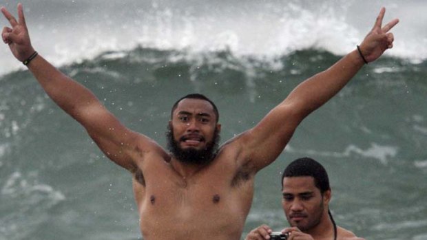 Does my bum look big in these? ... NSW prop Sekope Kepu throws some shapes in the Durban surf while camera-wielding second-rower Sitaleki Timani seems to be enjoying his rear-view position.