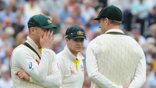 Captain Michael Clarke speaks with Adam Voges, right, and Steven Smith during day two at Trent Bridge.