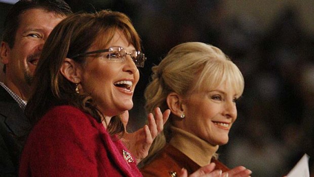 Cindy McCain, right, shares a laugh with Sarah Palin during an October 2008 campaign rally.