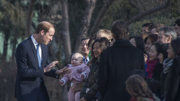 Prince William speaks with people at the British ambassador's official residence on Monday in Beijing.