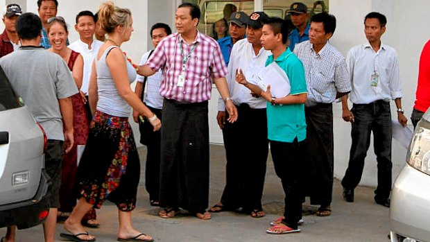 A woman identified as a crash survivor outside a Yangon hospital.