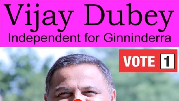 Independent candidate for Ginninderra Vijay Dubey with his election poster. And, yes, the red dot is meant to be there.