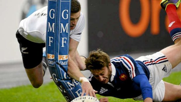 France's Maxime Medard stops a try by Cory Jane.