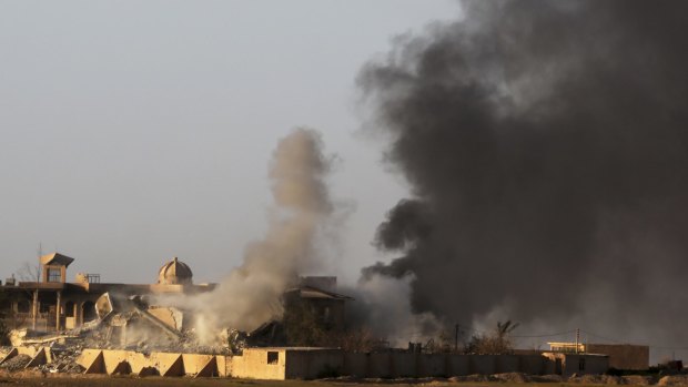 Smoke rises from buildings in Tikrit during clashes between Iraqi security forces and Islamic State militants on Thursday. 