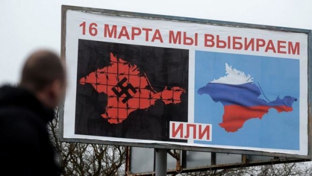 Strong message: Pro-Russia billboards show two visions of Crimea - one with a Russian flag, the other with a giant black swastika.