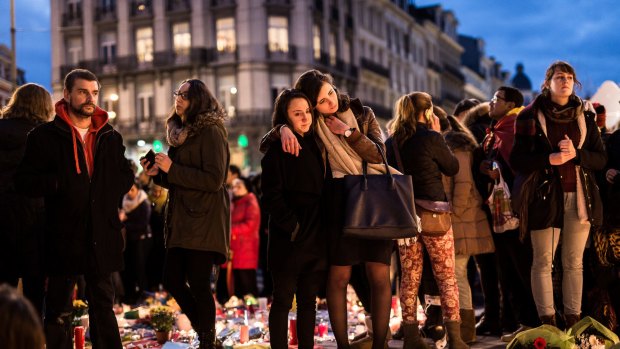 People gather at a memorial site located at the old stock exchange in Brussels on Wednesday.