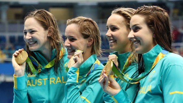 Australia's Cate Campbell, Bronte Campbell, Emma McKeon and Brittany Elmslie, from left, hold their gold medals after winning the women's 4x100-meter freestyle final setting a new world record during the swimming competitions at the 2016 Summer Olympics, Saturday, Aug. 6, 2016, in Rio de Janeiro, Brazil. (AP Photo/Lee Jin-man)