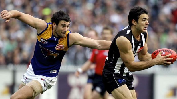 Fleeted-footed: Magpies defender Chris Tarrant evades a tackle by Eagles forward Josh Kennedy.