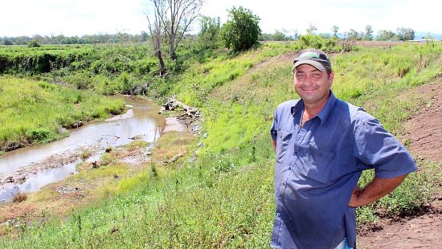 Darren Jahnke shows the revegetated stream bank beside his flood affected Lockyer Vally farm.