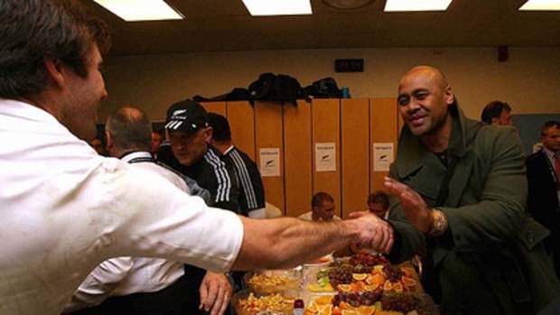 JOB WELL DONE: Jonah Lomu (right) congratulates Conrad Smith in the dressing room after the All Blacks beat France in Marseille.