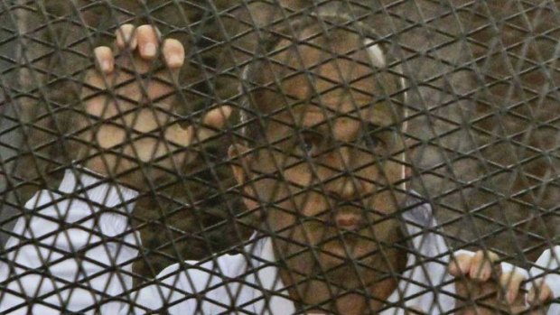 Al-Jazeera journalist Peter Greste  inside the defendants' cage
