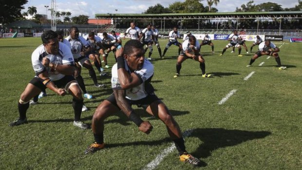 War dance: The Fijian national team lay down a challenge ahead of kick-off.