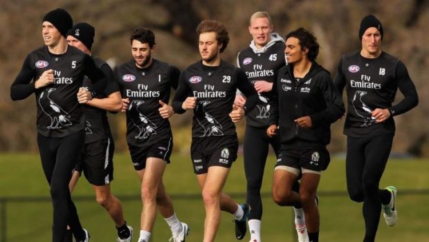 Leading from front: Nick Maxwell (left) and Magpie  teammates on a training run.