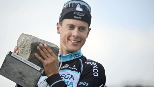 The Netherland's Niki Terpstra from Omega Pharma-Quick Step holds his trophy after winning the 112th edition of the Paris-Roubaix cycling classic.