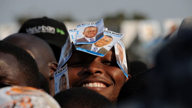 A supporter of opposition leader Kizza Besigye smiles at a rally this week.