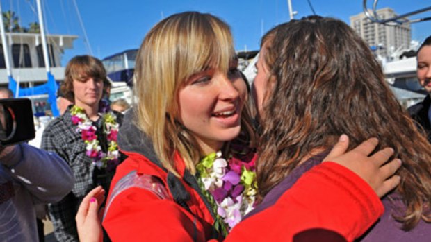 Abby Sunderland, left, 16, gets a hug from friend Casey Nash, right, before leaving for her world record attempting solo journey around the world.
