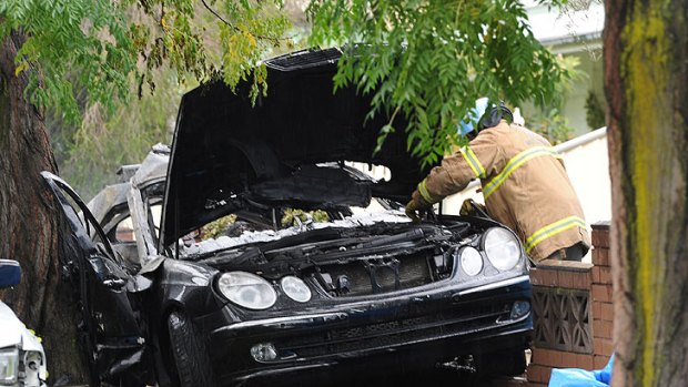 The late-model Mercedes became wedged between a tree and a garden wall, trapping those inside.