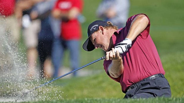 Tough day: Ernie Els plays out of a bunker on the way to a first-round 71.