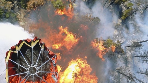 Water bombs away: A Bambi water bucket dumping its contents on a hot spot in the High Park fire.