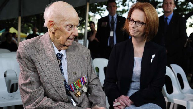 Prime Minister Julia Gillard talks with former P.O.W Sidney King at the dawn service in Townsville.