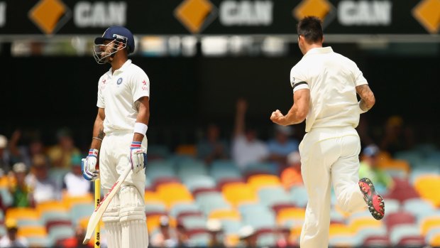 Turning point: Mitchell Johnson bowls Virat Kohli on the fourth and final day in Brisbane.