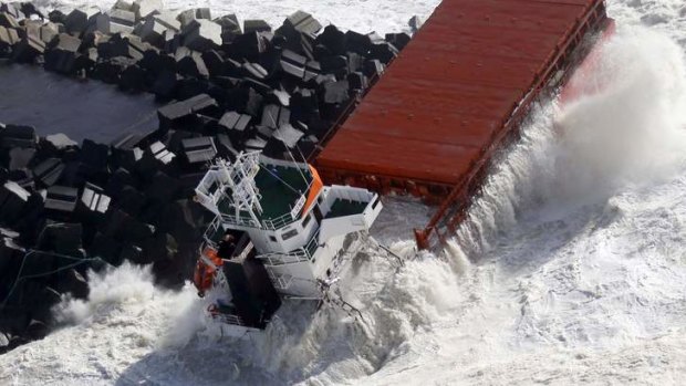 A Spanish cargo ship carrying fertiliser broke in two after hitting a sea wall off the coast of France in high winds.