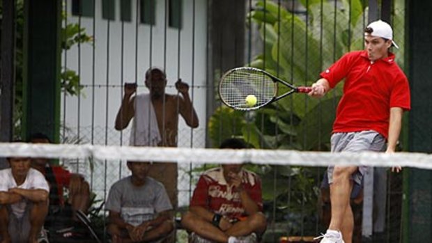 Australian death-row inmate Scott Rush hits a forehand during  yesterday's tennis tournament at Bali's Kerobokan prison.