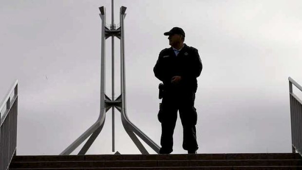 Australian Federal Police officers lock down the ministerial entrance to Parliament House in Canberra on Monday.