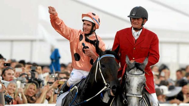 Jockey Luke Nolen salutes the crowd after winning the TJ Smith Stakes aboard the undefeated Black Caviar.