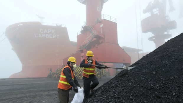 Chinese workers taking samples of imported coal at a port in Rizhao.