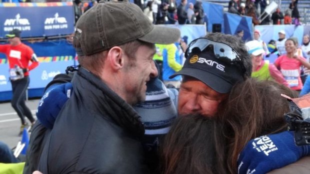 Well done mate: An emotional Gus Worland is congratulated by Hugh Jackman after completing the NYC marathon in six hours, 29 minutes.