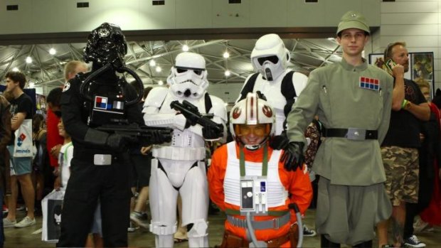 These five men have dressed up as Star Wars characters, Daniel Kettle as Tie Pilot, Leo Faino as a Stormtrooper, Daniel Brace as an X-wing Pilot, Josh Smith as Biker Scout, and Andrew Pill as an Imperial Officer at Supanova.